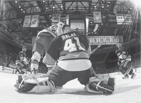  ?? BRUCE BENNETT/Getty Images ?? A shot by Nicklas Backstrom of the Washington Capitals floats over the shoulder of Jaroslav Halak of the New York Islanders in overtime in Game 4.