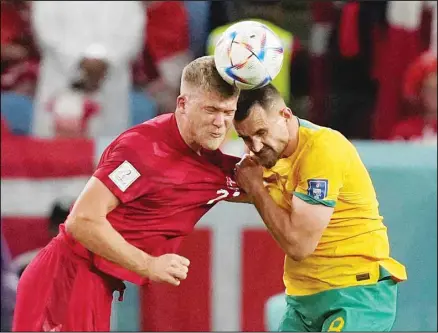  ?? ?? Denmark’s Andreas Cornelius (left), goes for the header with Australia’s Bailey Wright during the World Cup Group D soccer match between Australia and Denmark, at the Al Janoub Stadium in Al Wakrah, Qatar. (AP)