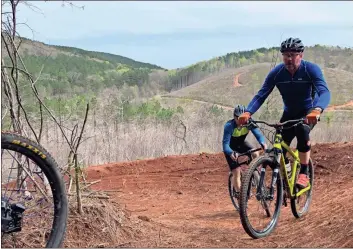  ?? John Bailey ?? Stacey Carver of Rockmart rides a portion of the Pinhoti trail just south of Cave Spring.