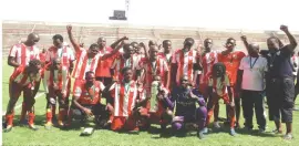  ??  ?? BULAWAYO City players and officials celebrate winning the Zifa Southern Region Division One title at Barbourfie­lds Stadium yesterday which marked their return to the Premier Soccer League