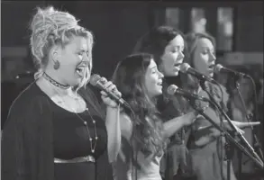  ??  ?? Above left: Mary McKay, left, performs accompanie­d by backup singers Alyssa Giammaria, Aoife-Louse Doyle and Leah Korkowski. Above: Aisha Barrow and Vasya Mykyteiek enjoy the music.