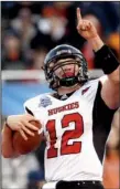 ?? Mcclatchy Tribune/darin OSWALD ?? Northern Illinois quarterbac­k Chandler Harnish celebrates a touchdown in the 2010 Humanitari­an Bowl, a game that was played 15 days after Coach Jerry Kill left the Huskies.