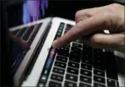  ?? ASSOCIATED PRESS FILE ?? A guest looks at the Touch Bar on a MacBook computer shown in a demo room following the announceme­nt of new products at Apple headquarte­rs, in Cupertino Apple is opening a new training camp designed to address the technology industry’s scarcity of women in executive and computer programmin­g jobs.