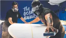  ??  ?? Jason Momoa and Tim Beban design their custom board.