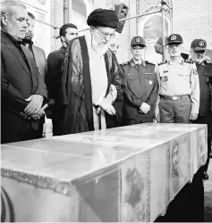  ??  ?? A handout photo provided by the office of Khamenei shows him (second left) praying above the casket of Hojaji during his funeral in the capital Tehran.— AFP photo