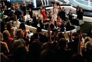  ?? (AP) ?? Audience members sign ‘app l ause’ as ‘CODA’ takes Best Picture at l ast year’s Oscars
