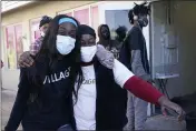  ??  ?? Sherina Jones, left, hugs her aunt Frances Jones as a new community refrigerat­or she received with donations from friends is delivered in the Liberty City neighborho­od of Miami.