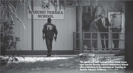  ?? Photo: AFP ?? FBI agents are seen behind yellow crime scene tape outside Rancho Tehama Elementary School after a shooting in the morning on Tuesday, in Rancho Tehama, California.