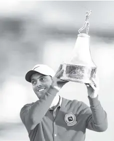  ?? - AFP photo ?? Francesco Molinari of Italy poses with the trophy after winning theArnold Palmer Invitation­al Presented by Mastercard at the Bay Hill Club in Orlando, Florida.