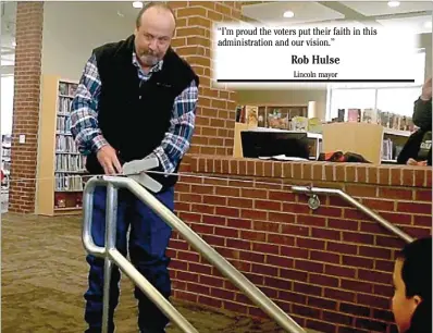  ?? COURTESY OF SCOTT DAVIS ?? Lincoln Mayor Rob Hulse cut the ribbon at the steps leading from the lounge area at the front of the library to the main area of the 10,000 square-foot new Lincoln Public Library.