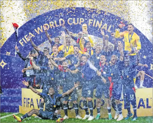  ??  ?? French players celebrate as they hold their World Cup trophy during the ceremony at the end of the final.