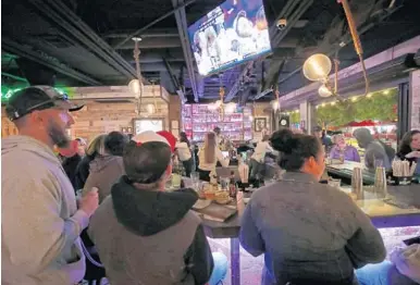  ?? JOHN MCCALL/SOUTH FLORIDA SUN SENTINEL PHOTOS ?? Patrons congregate around the bar at Tacocraft Taqueria & Tequila Bar in Lauderdale-by-the-Sea on Feb. 2. LBTS destinatio­ns are creating a vibe attractive to a mix of youthful locals and visitors.