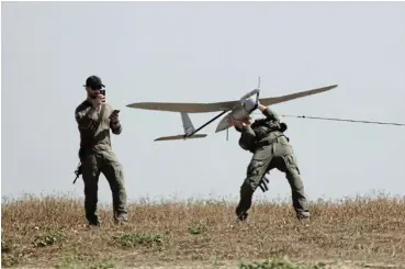  ?? /Amir Levy/Getty Images ?? Deadly drone: Israeli soldiers retrieve a deadly drone near the border with the Gaza Strip on Monday in southern Israel. Israel’s allies, including the UK and US, have urged the country to avoid escalation of conflict with Iran after its weekend attack.