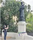  ?? PHOTO: NICK ANSELL/PA ?? A woman takes a picture of the statue of Emmeline Pankhurst in Victoria Tower Gardens