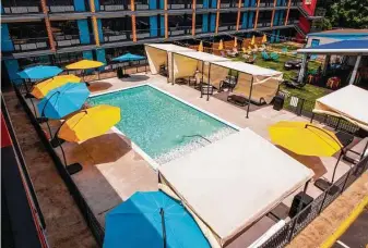  ??  ?? Colorful umbrellas surround the swimming pool for those who want to be outdoors without baking in the sun.