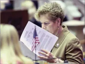  ??  ?? Assemblywo­man Ellen Jaffee, D-Suffern, works in the Assembly Chamber as legislativ­e members work on the state budget at the state Capitol on Friday.