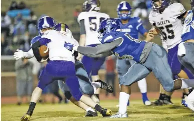  ?? STAFF PHOTO BY TROY STOLT ?? Red Bank middle linebacker Alex Lacy gets his hands on Grundy County quarterbac­k Jacob Dixon to make a tackle during a TSSAA Class 3A playoff game on Nov. 6. The Lions, who won that first-round matchup 50-6 and beat Brainerd 31-12 in last week’s second round, also at home, are set to host Region 3 rival Loudon in a quarterfin­al tonight.