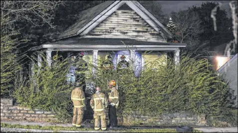  ?? JOHN SPINK / AJC ?? Atlanta Fire Rescue investigat­ors joined with ATF investigat­ors at the scene where a 3-month-old girl was killed on Paines Avenue in northwest Atlanta on March 23. The baby’s mother died from burns the next day.