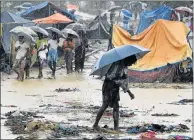  ?? Picture: AFP ?? MAJOR CRISIS: A Rohingya refugee holds an umbrella during rain in Bangladesh’s Balukhali refugee camp on Sunday