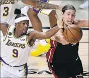  ??  ?? THE LAKERS’ Rajon Rondo battles for a loose ball with the Heat’s Kelly Olynyk in the fourth quarter.