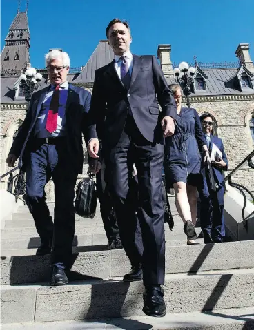  ?? SEAN KILPATRICK / THE CANADIAN PRESS ?? Natural Resources Minister James Carr and Finance Minister Bill Morneau leave a cabinet meeting to announce Ottawa is buying the Trans Mountain pipeline.