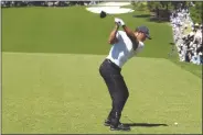  ?? GEORGE WALKER IV/AP ?? TIGER WOODS hits his tee shot on the first hole during third round at the Masters tournament at Augusta National Golf Club on Saturday in Augusta, Ga.