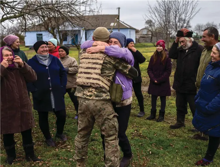  ?? ?? In the village of Vavylove, a Ukrainian serviceman embraces his mother for the first time since Russian troops attacked the Kherson region, southern Ukraine. Families were torn apart when Russia invaded in February, as some fled and others hunkered down. Now many are seeing one another for the first time in months, after Moscow's latest retreat amid a Ukrainian counteroff­ensive that has retaken a pocket of territory wedged between the regional capitals of Kherson and Mykolaiv and the Black Sea. (AP Photo/Bernat Armangue)