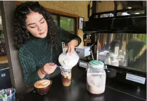  ?? — TNS ?? Garcia, 19, a barista at El K-Fe, making specialty coffee drinks. Casa Familiar, a social services non-profit, has opened the coffee cart at the San Ysidro Health Center to create barista jobs for youth in the San Diego area.