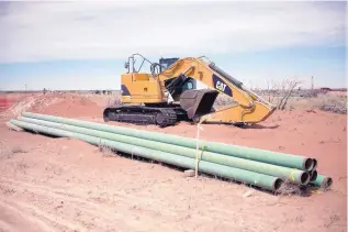  ??  ?? Companies are racing to install new pipelines for crude and natural gas in the Permian to alleviate the stress on current infrastruc­ture. Pictured are pieces of pipe about to be installed near Jal in southeaste­rn New Mexico.