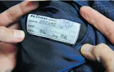  ??  ?? Master tailors in Italy sign off and number every Kiton item. This tag is found inside the inner breast pocket of a jacket.