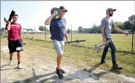  ?? NWA Democrat-Gazette/DAVID GOTTSCHALK ?? Jason May (from left), a volunteer, Wayne Tuck and Taylor Shelton, director of government affairs and sustainabi­lity with the Fayettevil­le Chamber of Commerce, carry fencing Friday for a parking perimeter at Mae Farm in Fayettevil­le for the annual NWA...