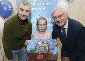  ??  ?? Tony Conaghy and Paul Brasill Chairman Drogheda Credit Union presenting Lydia Walsh Highly Commended Category 8-10 Yrs