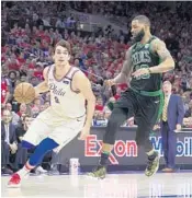  ?? MITCHELL LEFF/GETTY IMAGES ?? Dario Saric of Philadelph­ia drives to the basket against Marcus Morris of Boston in the fourth quarter Monday.