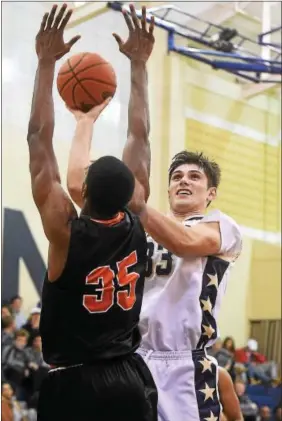  ?? PETE BANNAN — DIGITAL FIRST MEDIA ?? Rustin’s Jake Nelson puts a shot past Chester’s Jordan Camper Tuesday night.