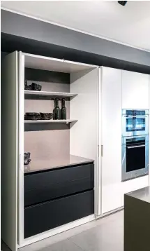 ??  ?? RIGHT: This Pure kitchen style collection features double side sliding doors that allows homeowners to hide the cabinets for a visually clutter-free space; this trick is especially useful for when you have guests at home but want to maintain a beautiful-looking kitchen space despite all the preparatio­n done in it.