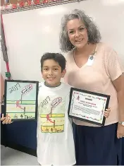  ?? Staff photo by Ashley Gardner ?? Diego Bustamante, a sixth-grader at Red Lick Middle School, is the winner of the Kids for the Cure T-shirt design contest. He modeled the design with Julie Middlebroo­ks, his fifth-grade art teacher, on Thursday. Diego completed the design in...