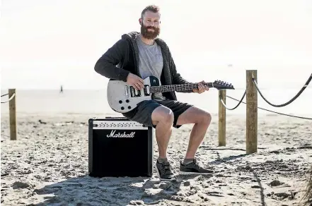  ?? BRADEN FASTIER/STUFF ?? Drew Fahey with the guitar he made by recycling plastic milk bottles.