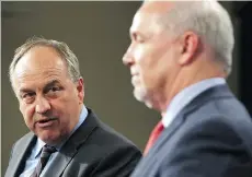  ?? CHAD HIPOLITO/THE CANADIAN PRESS/FILES ?? Green party Leader Andrew Weaver, left, is seeking cuts to greenhouse gas emissions and is threatenin­g to withdraw his support of Premier John Horgan’s government.