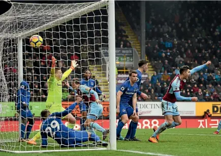  ?? PHOTO: AP ?? Chris Wood of Burnley, nearest the goalkeeper, scores his side’s winning goal during their Premier League victory over Everton.