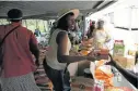  ?? Picture: FILE ?? SHARING: Stokvel member Princess Ngcobo passes groceries as her stokvel shares out purchases at a Durban store.