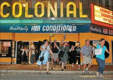  ?? BARRY TAGLIEBER — FOR DIGITAL FIRST MEDIA ?? Patrons reenact a famous scene from the 1958cult classic “The Blob” by running in terror from the Colonial Theatre during the annual Blobfest Friday in Phoenixvil­le.