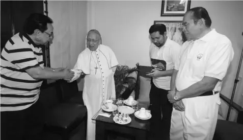  ?? JOY TORREJOS ?? Asean Inter-parliament­ary Assembly secretary general and former south district Rep. Antonio Cuenco, left, meets with Cebu Archbishop emeritus Ricardo Cardinal Vidal after a thanksgivi­ng mass at the Cathedral. With him is former Dangerous Drugs Board...