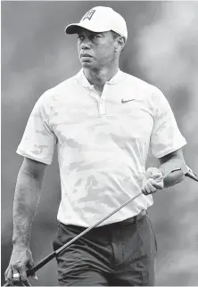  ?? Stuart Franklin / Getty Images ?? Tiger Woods sizes up Bellerive Country Club during Tuesday’s practice round in preparatio­n for the PGA Championsh­ip.