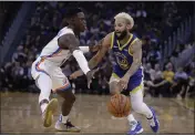  ??  ?? The Warriors’ Ky Bowman drives the ball against Thunder guard Dennis Schroder on Monday in San Francisco.