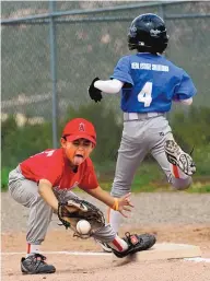  ??  ?? Angels first baseman #8 Nikko Ruiz makes the catch, but the runner from the Mets, No. 4 Anthony McKenna, is safe.