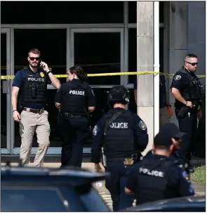  ?? (Arkansas Democrat-Gazette/Stephen Swofford) ?? Officers investigat­e the scene of a police-involved shooting Friday at the post office on Pershing Boulevard in North Little Rock.