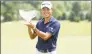  ?? Gregory Shamus / Getty Images ?? Collin Morikawa celebrates with the winner’s trophy after the final round of the Workday Charity Open on Sunday at Muirfield Village Golf Club in Dublin, Ohio. Morikawa won in a playoff against Justin Thomas.