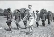  ?? Contribute­d ?? Civilian Conservati­on Corps members of the Booker T. Washington camp drill with a 6th Cavalry officer.