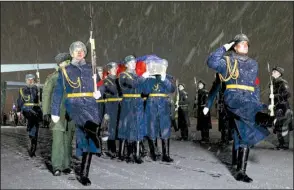  ?? AP/VADIM SAVITSKY ?? A Russian honor guard escorts a coffin with the body of Russian Lt. Col. Oleg Peshkov during a mourning ceremony Monday at Chkalovsky military airport outside Moscow. Peshkov was co-pilot of a jet that was shot down by a Turkish plane last week.