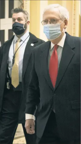  ??  ?? THE MASKED $LINGER: Senate Majority Leader Mitch McConnell arrives at the US Capitol on Monday as lawmakers were set to vote on the $2.3 trillion stimulus package. The House and Senate OK’d it hours later.